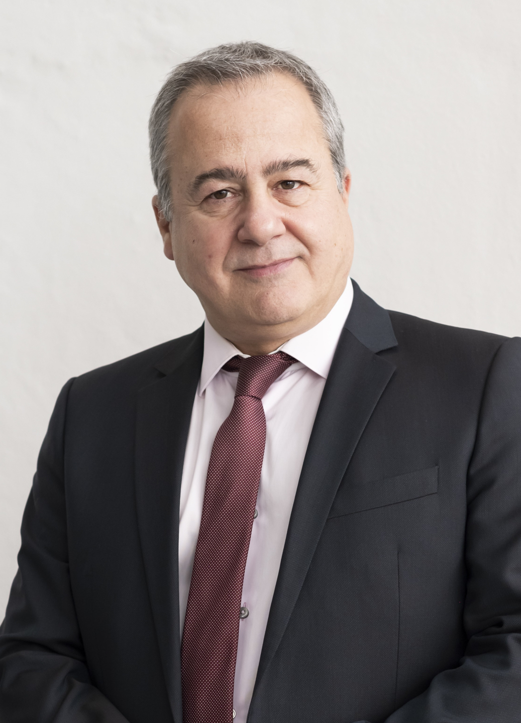 A person in a suit and tie
Description automatically generated